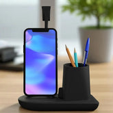 Black phone stand with smartphone displaying a colorful screen, pen holder with pens